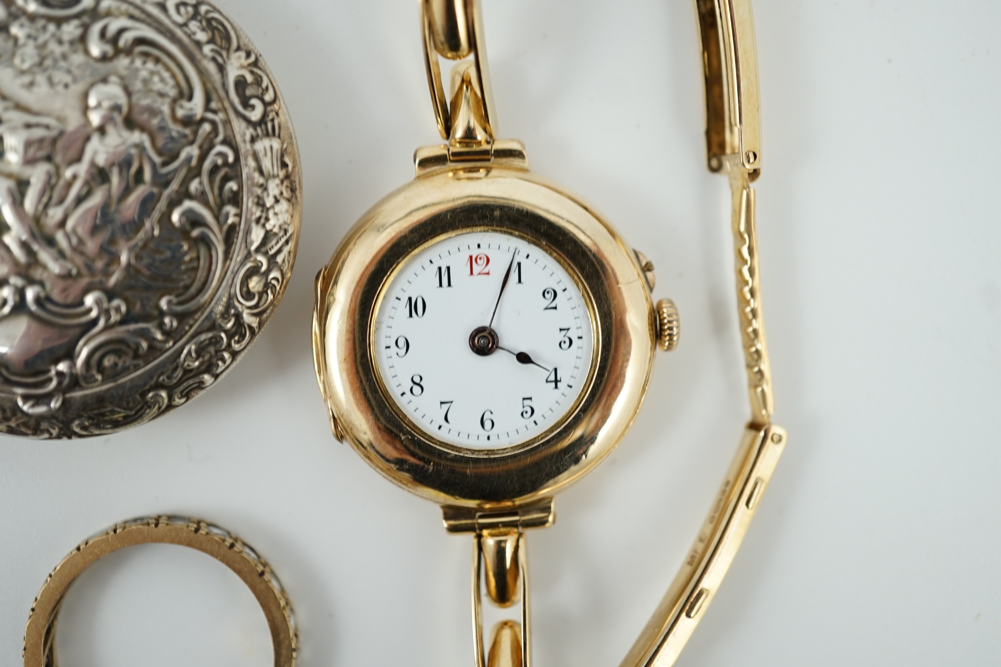 An early 20th century 9ct gold manual wind wrist watch, on a 15ct expanding bracelet, case diameter 28mm, gross weight 25.3 grams, a yellow metal and simulated diamond set eternity ring, A 1930's German git and enamel cr